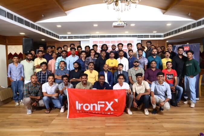 A group of people from the IronFX seminar posing together for a team photo.