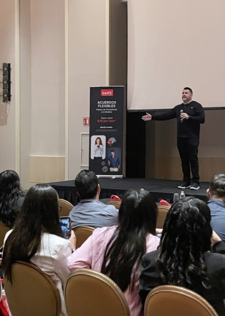A man delivering a speech to an audience during a meeting.
