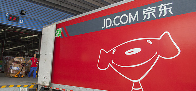 An image of a truck inside a warehouse, symbolizing the JD logo - a dog on a truck.