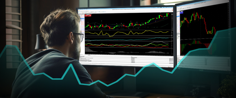 A man observes two monitors displaying a chart, analyzing data for insights and trends.