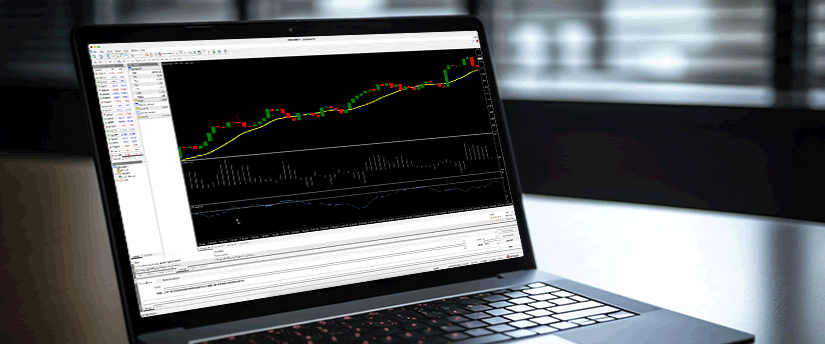 A laptop featuring a trading chart on the screen, showcasing financial data and market fluctuations.